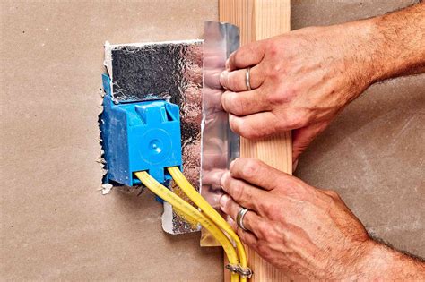 installing insulation around electrical boxes